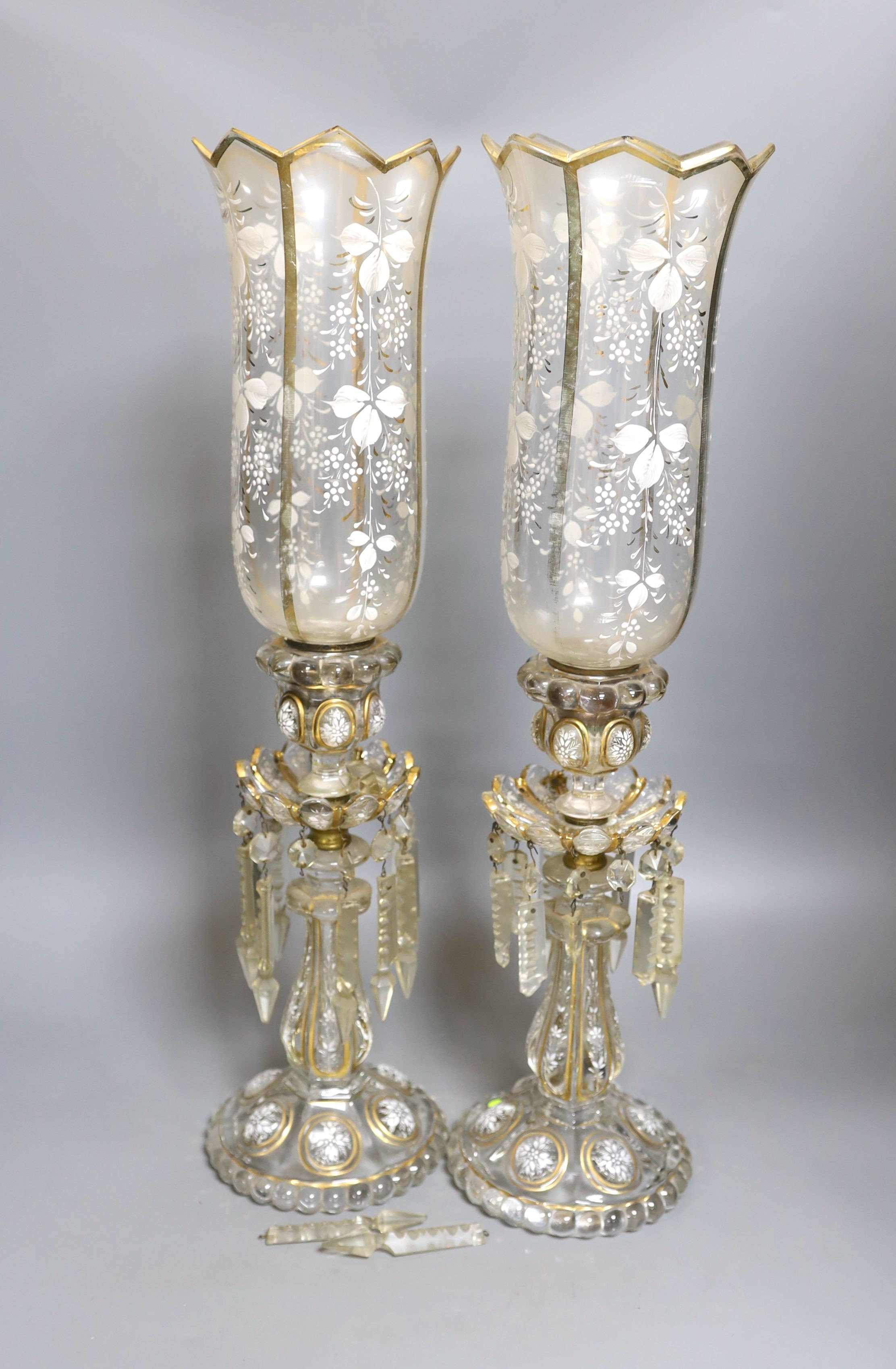 A pair of late 19th century French white-enamelled glass lustre hung storm lamps, 55cms high.